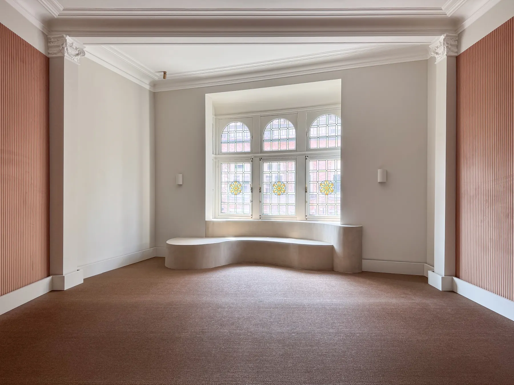 A grand piano with its lid raised in a quiet salon